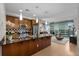 Open kitchen and living room featuring stainless appliances, black countertops, and breakfast bar at 2001 Lincoln St # 2412, Denver, CO 80202