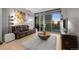 Cozy living room featuring modern art and an entertainment center, providing comfort and style at 2001 Lincoln St # 2412, Denver, CO 80202