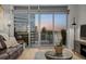 The living room provides gorgeous views of the city from this unit's private balcony at 2001 Lincoln St # 2412, Denver, CO 80202
