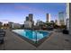 Relaxing pool area with comfortable lounge chairs and stunning skyline views at 2001 Lincoln St # 2412, Denver, CO 80202