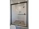 Sleek bathroom featuring a glass shower enclosure with white tiled walls and black hardware at 1372 Lowell Blvd # 1, Denver, CO 80204