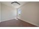 Minimalist bedroom with neutral tones, carpet floors, and a large window offering natural light at 1372 Lowell Blvd # 1, Denver, CO 80204