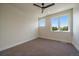 Bright, airy bedroom with neutral carpet, a modern ceiling fan, and ample natural light at 1372 Lowell Blvd # 1, Denver, CO 80204