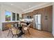 Modern kitchen and dining area featuring stainless appliances, wood cabinets, and white countertop at 1372 Lowell Blvd # 1, Denver, CO 80204