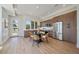Modern kitchen and dining area with stainless steel appliances, light wood floors at 1372 Lowell Blvd # 1, Denver, CO 80204