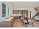 Modern kitchen and dining area with stainless appliances and white countertops at 1372 Lowell Blvd # 1, Denver, CO 80204