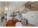 Well-decorated living area with fireplace, sofa, stairs, and view of kitchen at 1372 Lowell Blvd # 1, Denver, CO 80204
