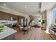 Bright living room with modern kitchen, dining area, wood floors, and stairs at 1372 Lowell Blvd # 1, Denver, CO 80204