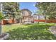 Large, well-maintained backyard with lush lawn and a stone patio, perfect for outdoor gatherings at 16376 Flintlock Ct, Parker, CO 80134