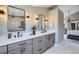 Modern bathroom with dual sinks, elegant fixtures, and a glass-enclosed shower at 16376 Flintlock Ct, Parker, CO 80134