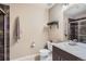 Nicely lit bathroom featuring a neutral color palette, shower, toilet, sink, and decorative elements at 16376 Flintlock Ct, Parker, CO 80134