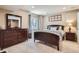 Cozy bedroom features a full-sized bed, dresser with mirror, and a wooden windowsill decoration at 16376 Flintlock Ct, Parker, CO 80134