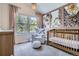 Charming Bedroom with a crib, comfortable chair, and scenic views from the windows at 16376 Flintlock Ct, Parker, CO 80134