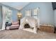 Bright bedroom featuring a cute play tent with a comfy chair and stylish wicker chest at 16376 Flintlock Ct, Parker, CO 80134