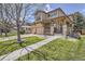 Charming two-story home featuring a welcoming porch with stone accents and a well-manicured front yard at 16376 Flintlock Ct, Parker, CO 80134