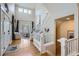 Bright and airy foyer with hardwood floors, soaring ceilings, and a staircase to the upper level at 16376 Flintlock Ct, Parker, CO 80134
