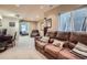 Spacious living room boasts a comfortable leather sofa, adjacent to a desk workspace with natural light at 16376 Flintlock Ct, Parker, CO 80134