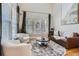 Elegant living room featuring large windows, hardwood floors, and a stylish seating area at 16376 Flintlock Ct, Parker, CO 80134