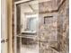 Attractive tilework adorns the shower, complete with glass door, chrome fixtures, and a built-in niche at 16376 Flintlock Ct, Parker, CO 80134