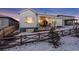 Snowy backyard with a wooden fence and patio at 14319 Hop Clover St, Parker, CO 80134