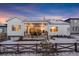 White house with covered patio and fenced backyard at 14319 Hop Clover St, Parker, CO 80134