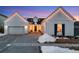 Stunning farmhouse exterior with charming string lights and landscaping at 14319 Hop Clover St, Parker, CO 80134