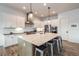 Modern kitchen with large island, stainless steel appliances, and white cabinetry at 14319 Hop Clover St, Parker, CO 80134