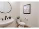 Small powder room with toilet and sink at 14319 Hop Clover St, Parker, CO 80134