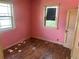 Bedroom with hardwood floors, natural light, and light pink walls at 54 E Cornell Ave, Englewood, CO 80113
