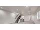 Finished basement featuring gray carpet, a wet bar, modern black railing, and access to a finished room at 536 Cook St, Denver, CO 80206