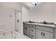 Modern bathroom with double sink vanity, subway tile shower and marble-look floor at 536 Cook St, Denver, CO 80206