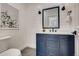 Stylish powder room features a navy vanity, white countertop, and modern fixtures at 536 Cook St, Denver, CO 80206