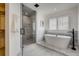 Spa-like bathroom features a glass enclosed shower and a soaking tub at 536 Cook St, Denver, CO 80206