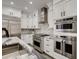 Well-appointed kitchen with stainless steel appliances, a stylish backsplash, and ample cabinet space, combining functionality with elegance at 536 Cook St, Denver, CO 80206