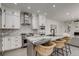 Elegant kitchen featuring a granite-topped island with seating and stainless steel appliances, perfect for modern living at 536 Cook St, Denver, CO 80206