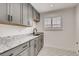 Laundry room with granite counters, ample cabinet space, and modern fixtures at 536 Cook St, Denver, CO 80206