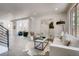 Open-concept living room with sleek furnishings, modern art, and large windows, highlighting the spacious design at 536 Cook St, Denver, CO 80206