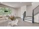 Bright living room with a large window, modern staircase, and neutral-toned decor, creating an inviting atmosphere at 536 Cook St, Denver, CO 80206