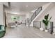 Spacious living room featuring modern black railing staircase and natural light, complemented by stylish decor and light wood flooring at 536 Cook St, Denver, CO 80206