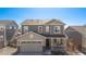 Charming two-story house featuring a covered front porch, neutral siding, and an attached two-car garage at 753 Audubon Peak Dr, Erie, CO 80516