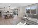 Bright living room featuring hardwood floors, a gray sectional sofa, and sliding doors leading to the backyard at 753 Audubon Peak Dr, Erie, CO 80516