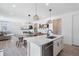 Spacious living room featuring an open floor plan with dining, a modern fireplace, and lots of natural light at 753 Audubon Peak Dr, Erie, CO 80516