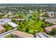Scenic aerial view of a community with lush landscaping, a golf course, and several small ponds at 9320 E Center Ave # 4B, Denver, CO 80247