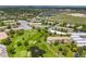 Overhead shot of an apartment community featuring mature trees, a small golf green, and a decorative pond at 9320 E Center Ave # 4B, Denver, CO 80247
