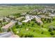 Aerial view of a community featuring a golf course, mature trees, and ample parking at 9320 E Center Ave # 4B, Denver, CO 80247