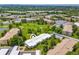 Aerial view of a residential complex with golf course, lake, and mature trees at 9320 E Center Ave # 4B, Denver, CO 80247