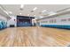 Spacious auditorium with stage, hardwood floor, and ample seating for events and gatherings at 9320 E Center Ave # 4B, Denver, CO 80247