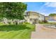 Well-maintained condo building with manicured lawn and mature trees in a desirable community at 9320 E Center Ave # 4B, Denver, CO 80247