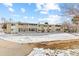 Exterior view of well-maintained building with snow-covered courtyard and walkways at 9320 E Center Ave # 4B, Denver, CO 80247