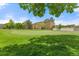 Beautiful green lawn featuring mature trees and golf green in a serene residential setting at 9320 E Center Ave # 4B, Denver, CO 80247